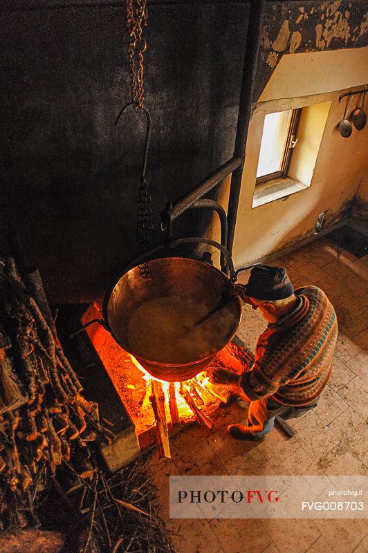 In the dairy of malga Ielma the dairyman making cheese and butter sa once again, warming the milk with the fire of wood