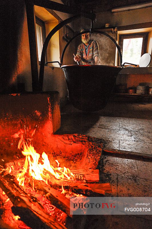 In the dairy of malga Ielma the dairyman making cheese and butter sa once again, warming the milk with the fire of wood