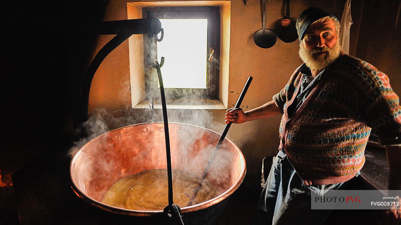 In the dairy of malga Ielma the dairyman making cheese and butter sa once again, warming the milk with the fire of wood