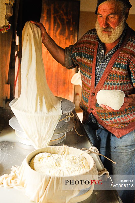 In the dairy of malga Ielma the dairyman making cheese and butter sa once again, warming the milk with the fire of wood