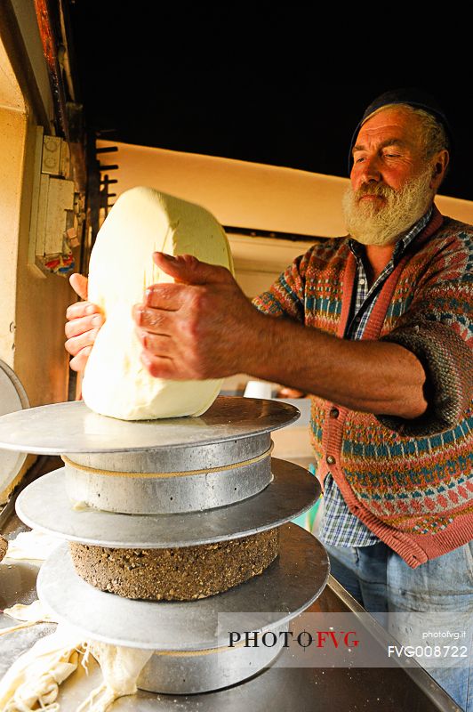 In the dairy of malga Ielma the dairyman making cheese and butter sa once again, warming the milk with the fire of wood