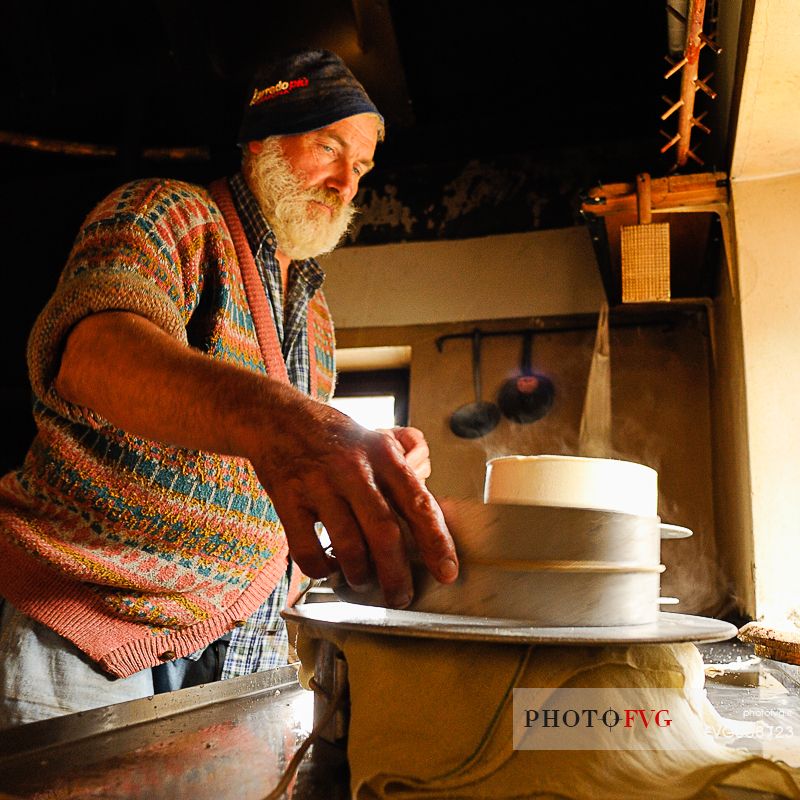 In the dairy of malga Ielma the dairyman making cheese and butter sa once again, warming the milk with the fire of wood