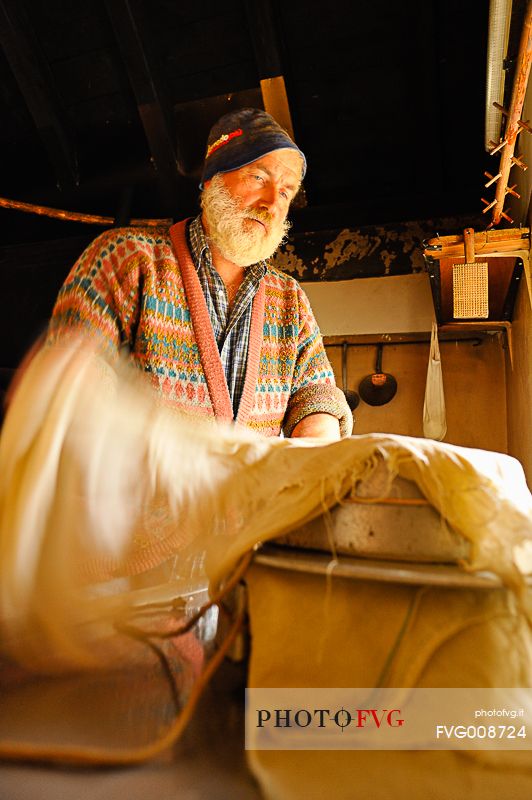 In the dairy of malga Ielma the dairyman making cheese and butter sa once again, warming the milk with the fire of wood