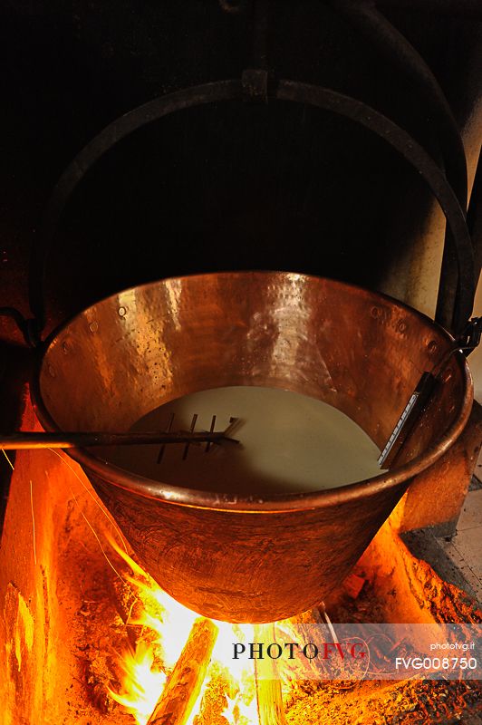 In the dairy of malga Ielma the dairyman making cheese and butter sa once again, warming the milk with the fire of wood