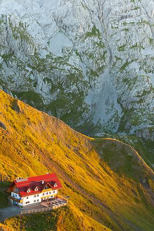 Warm light of sunrise lights-up the Marinelli refuge