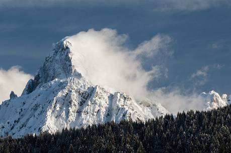 Clouds come off the mountain Sernio after a snowfall 