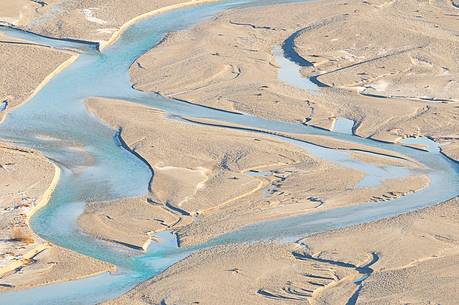 The crystal and clear waters of Tagliamento river flowing in its wild and wonderful bed