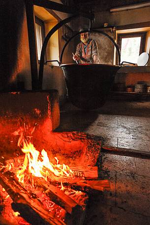 In the dairy of malga Ielma the dairyman making cheese and butter sa once again, warming the milk with the fire of wood