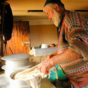 In the dairy of malga Ielma the dairyman making cheese and butter sa once again, warming the milk with the fire of wood