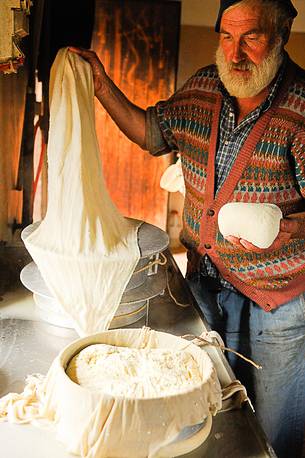 In the dairy of malga Ielma the dairyman making cheese and butter sa once again, warming the milk with the fire of wood