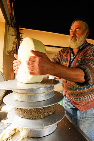 In the dairy of malga Ielma the dairyman making cheese and butter sa once again, warming the milk with the fire of wood