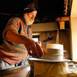 In the dairy of malga Ielma the dairyman making cheese and butter sa once again, warming the milk with the fire of wood