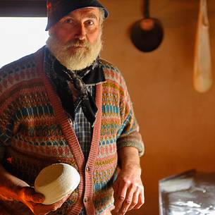 In the dairy of malga Ielma the dairyman making cheese and butter sa once again, warming the milk with the fire of wood