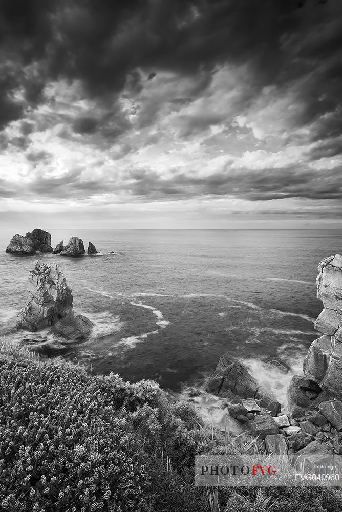 A cloudy and dynamic view of the magical cliffs on the Atlantic Ocean at the Bajos de Arnia in Cantabria, Spain