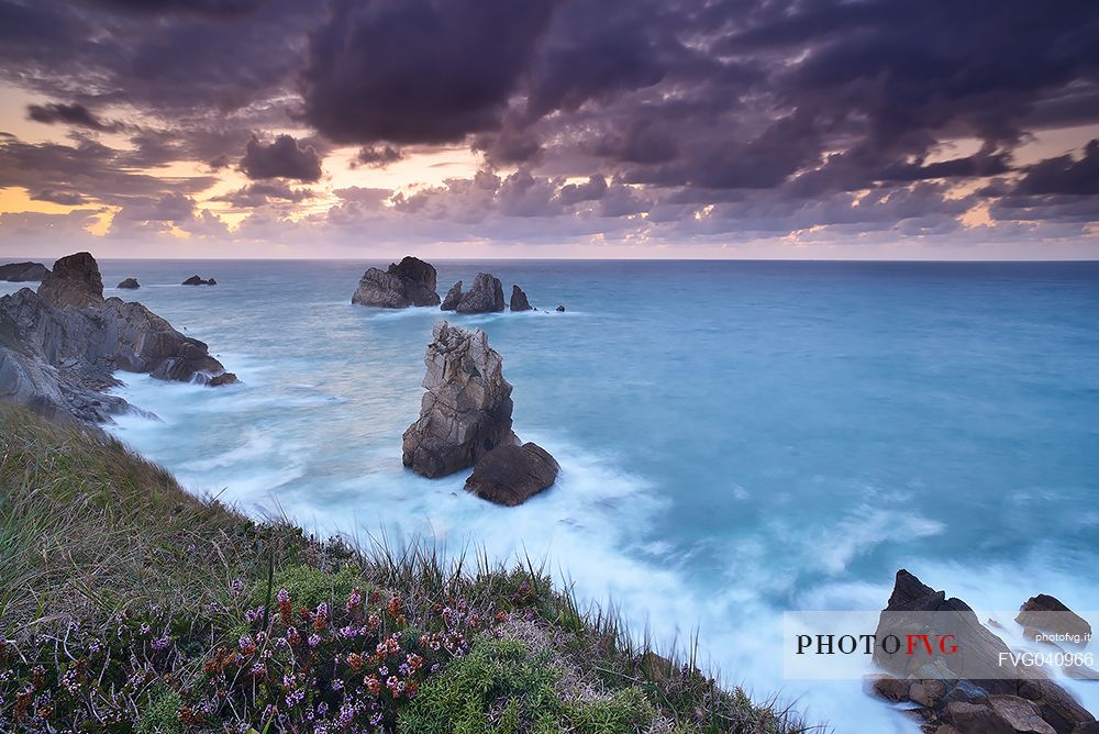 A dynamic sunset on the magical cliffs on the Atlantic Ocean at the Bajos de Arnia in Cantabria, Spain, Europe