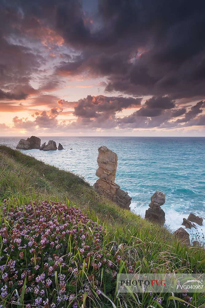 A dynamic sunset on the magical cliffs on the Atlantic Ocean at the Bajos de Arnia in Cantabria, Spain, Europe