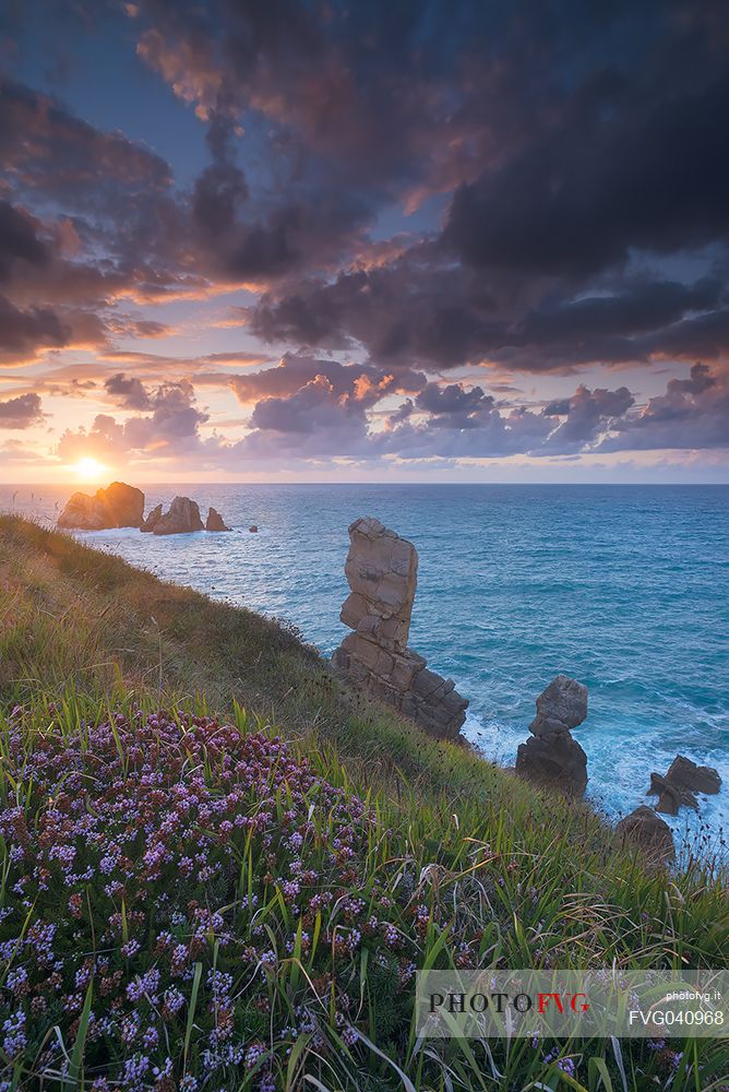 A dynamic sunset on the magical cliffs on the Atlantic Ocean at the Bajos de Arnia in Cantabria, Spain, Europe