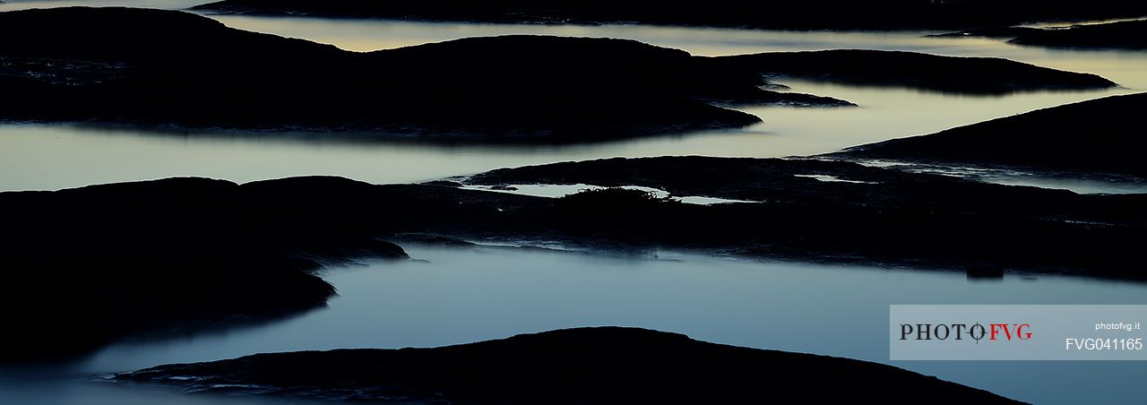 An intimate abstract view of rocks of Garda Lake in Sirmione, Brescia, Lombardy, Italy, Europe