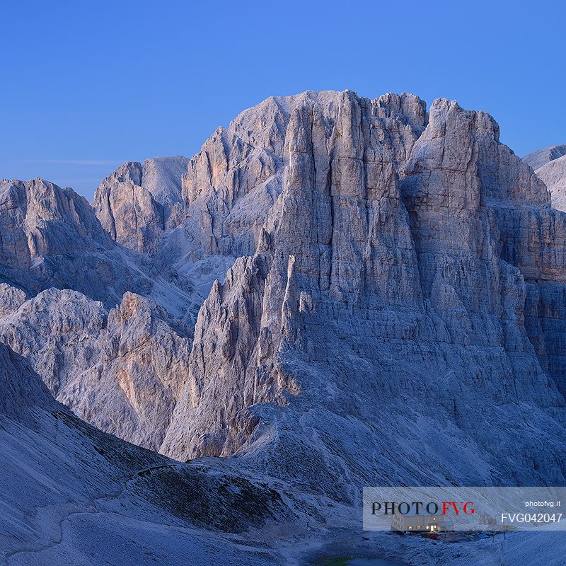 Twilight on the Torri del Violet peak and the hut Re Alberto lighting, Cattinaccio mountain range, fassa valley, dolomites, Trentino Alto Adige, Italy, Europe