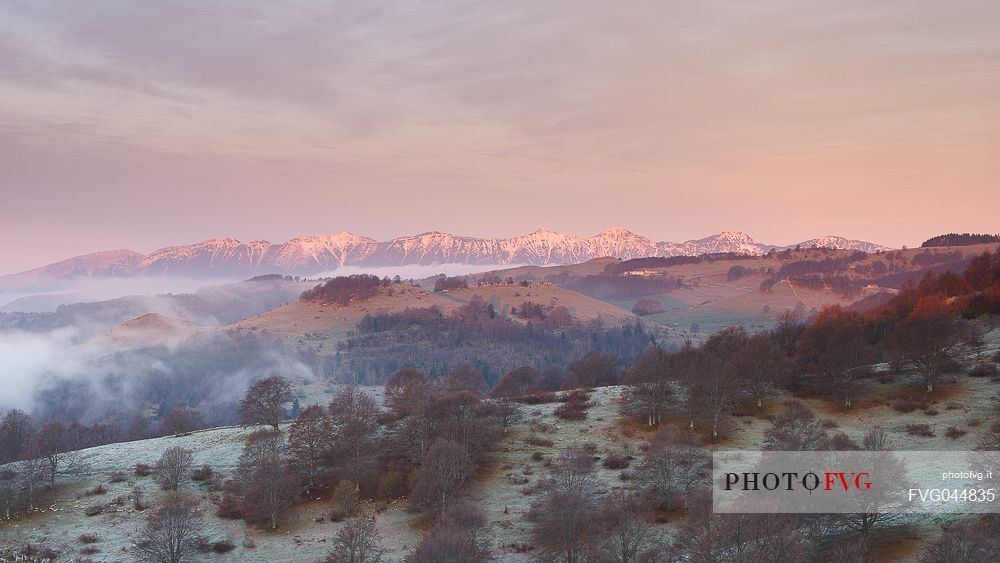 A quietly and cold dawn of autumn in Lessinia, looking over the low clouds toward Monte Baldo from Parpari in the Lessinia Natural Park, Veneto, Italy, Europe