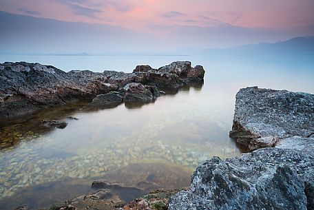 Sunset from Baia delle Sirene on the eastern coast of Garda Lake, in the background the Mount Pizzocolo, Verona, Veneto, Italy, Europe