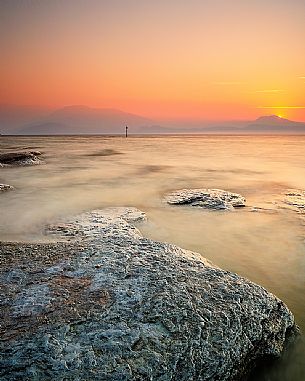Garda lake at sunrise from Sirmione coast, in the background the Mount Baldo and the Mount Pastello, Brescia, Lombardy, Italy, Europe