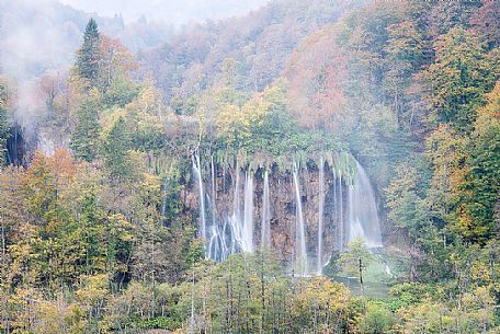 A vision of a waterfall in the colorful autumn forest in the Plitvice national park, Dalmatia, Croatia, Europe A vision of a waterfall in the colorful autumn forest in the Plitvice national park, Dalmatia, Croatia, Europe