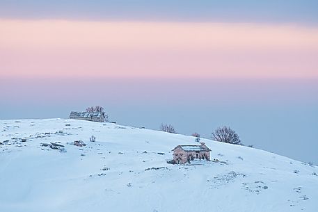 A quietly and cold dawn of winter in Lessinia, looking toward Bagorno hut on the boundary of Lessinia Natural Park, Veneto, Italy, Europe