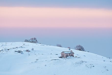 A quietly and cold dawn of winter in Lessinia, looking toward Bagorno hut on the boundary of Lessinia Natural Park, Veneto, Italy, Europe A quietly and cold dawn of winter in Lessinia, looking toward Bagorno hut on the boundary of Lessinia Natural Park, Veneto, Italy, Europe