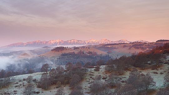 A quietly and cold dawn of autumn in Lessinia, looking over the low clouds toward Monte Baldo from Parpari in the Lessinia Natural Park, Veneto, Italy, Europe