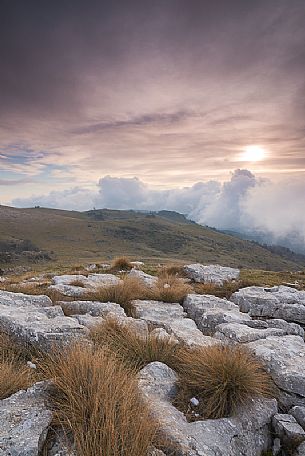 Before sunset in the Lessinia Natural Park watching toward sud from a peak near Malga Malera. In the distance we can see Malga Pigarolo and Malga Bagorno over the clouds. Before sunset in the Lessinia Natural Park watching toward sud from a peak near Malga Malera. In the distance we can see Malga Pigarolo and Malga Bagorno over the clouds.
