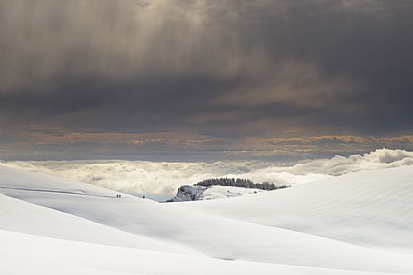 Winter trekking in the Lessinia Natural Park above the clouds that sourround the plain, Mount Potteghe, Bosco Chiesanuova, Veneto, Italy, Europe Winter trekking in the Lessinia Natural Park above the clouds that sourround the plain, Mount Potteghe, Bosco Chiesanuova, Veneto, Italy, Europe