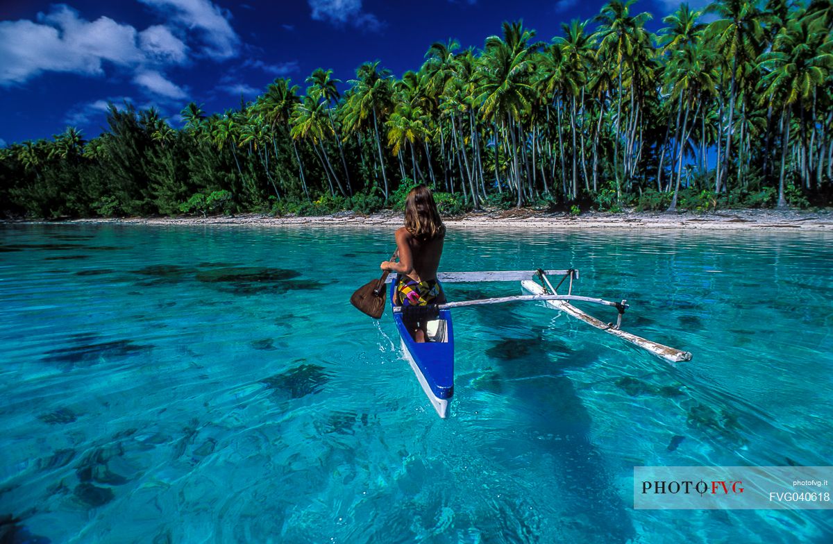 Woman on canoe, Moorea, Tahiti island, French Polynesia