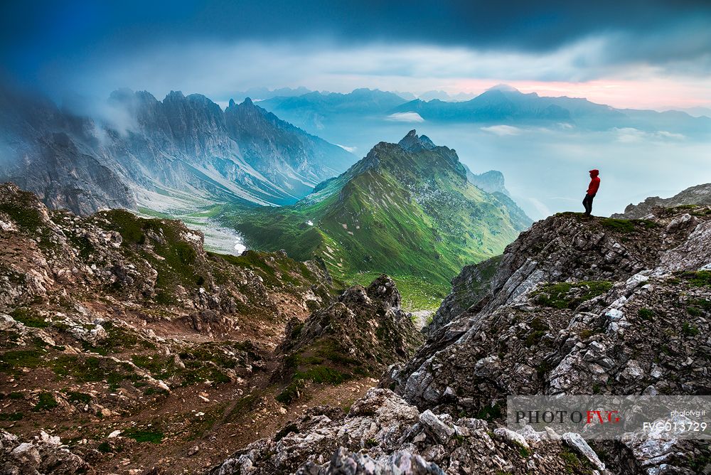 An hiker admires the amazing view over Passo di Suola.