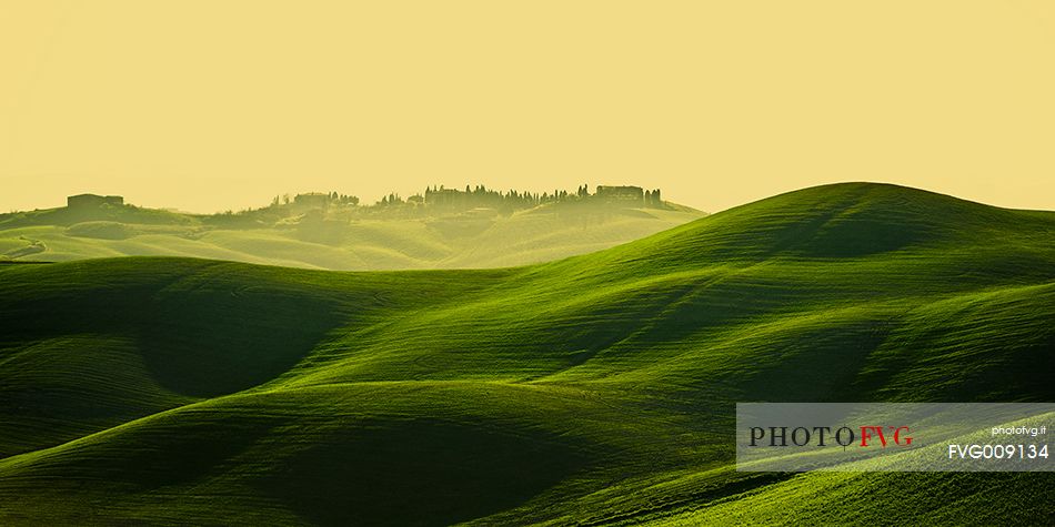 sunrise over the Crete Senesi in a misty morning