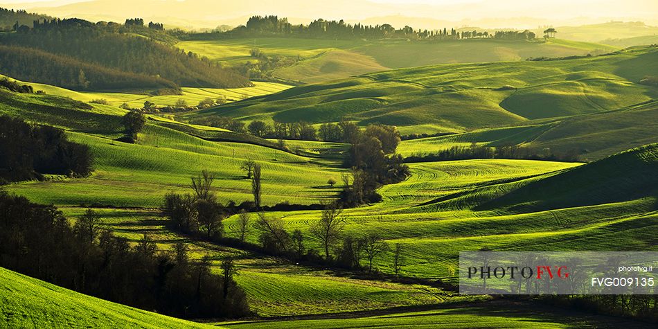 sunrise over the Crete Senesi in a misty morning