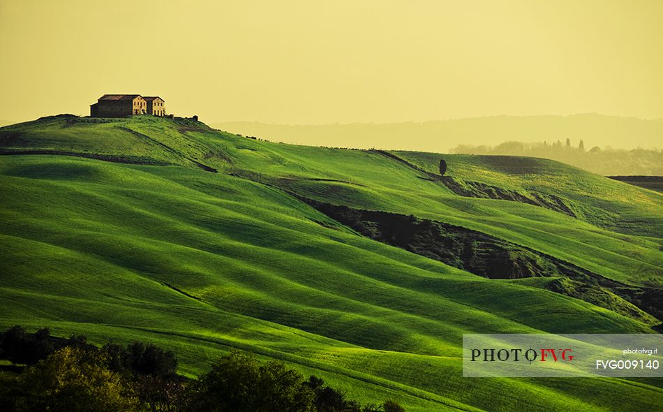 sunrise over the Crete Senesi in a misty morning