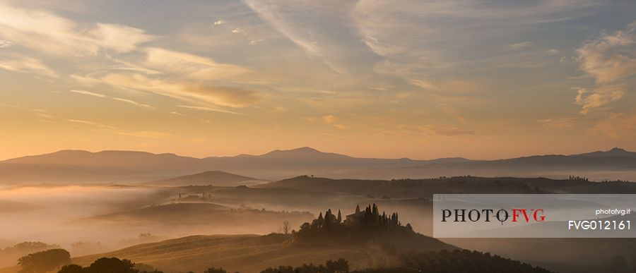 sunrise over the Crete Senesi in a misty morning