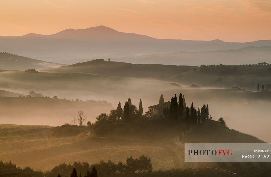 sunrise over the Crete Senesi in a misty morning