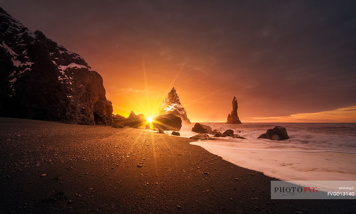 The black sand beach of Reynisfjara and the mount Reynisfjall from the Dyrholaey promontory in the southern coast of Iceland, Vik