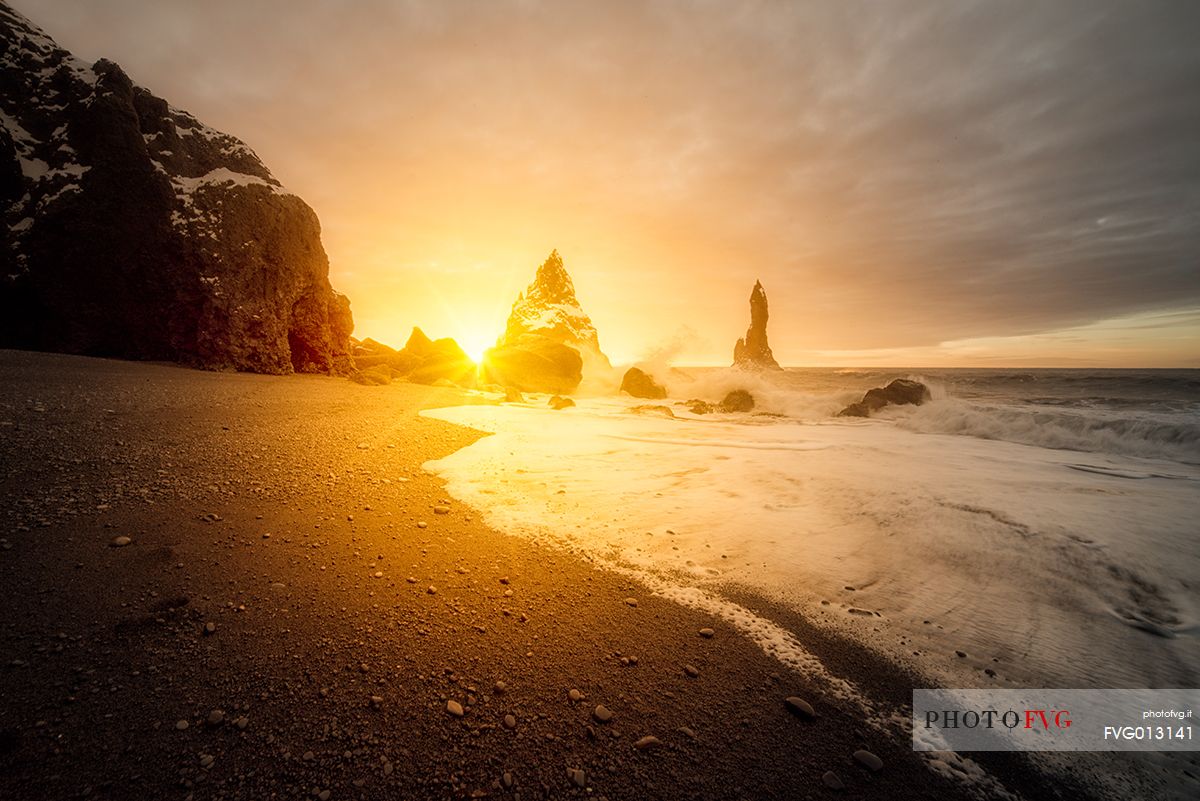 The black sand beach of Reynisfjara and the mount Reynisfjall from the Dyrholaey promontory in the southern coast of Iceland, Vik