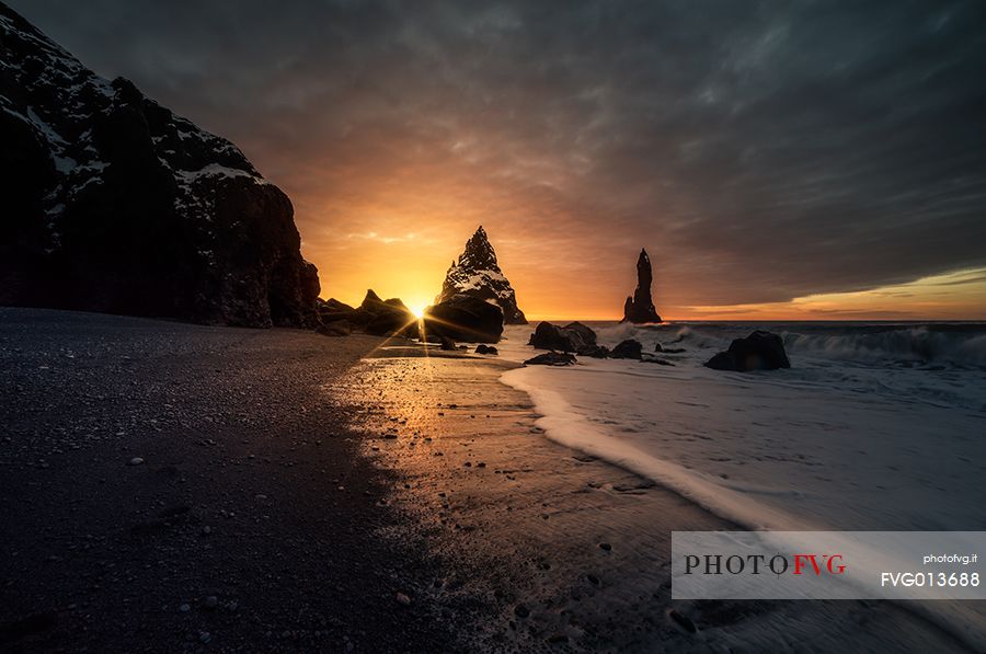 The black sand beach of Reynisfjara and the mount Reynisfjall from the Dyrholaey promontory in the southern coast of Iceland, Vik