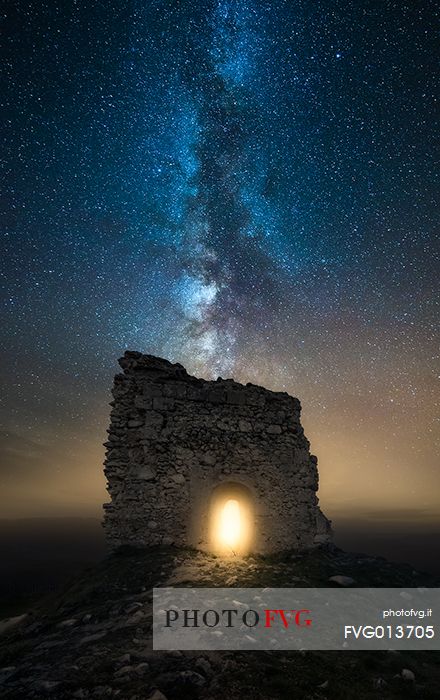 Milky way landscape over Calascio fortress, ancient village of Abruzzo, Gran Sasso and Monti della Laga national park