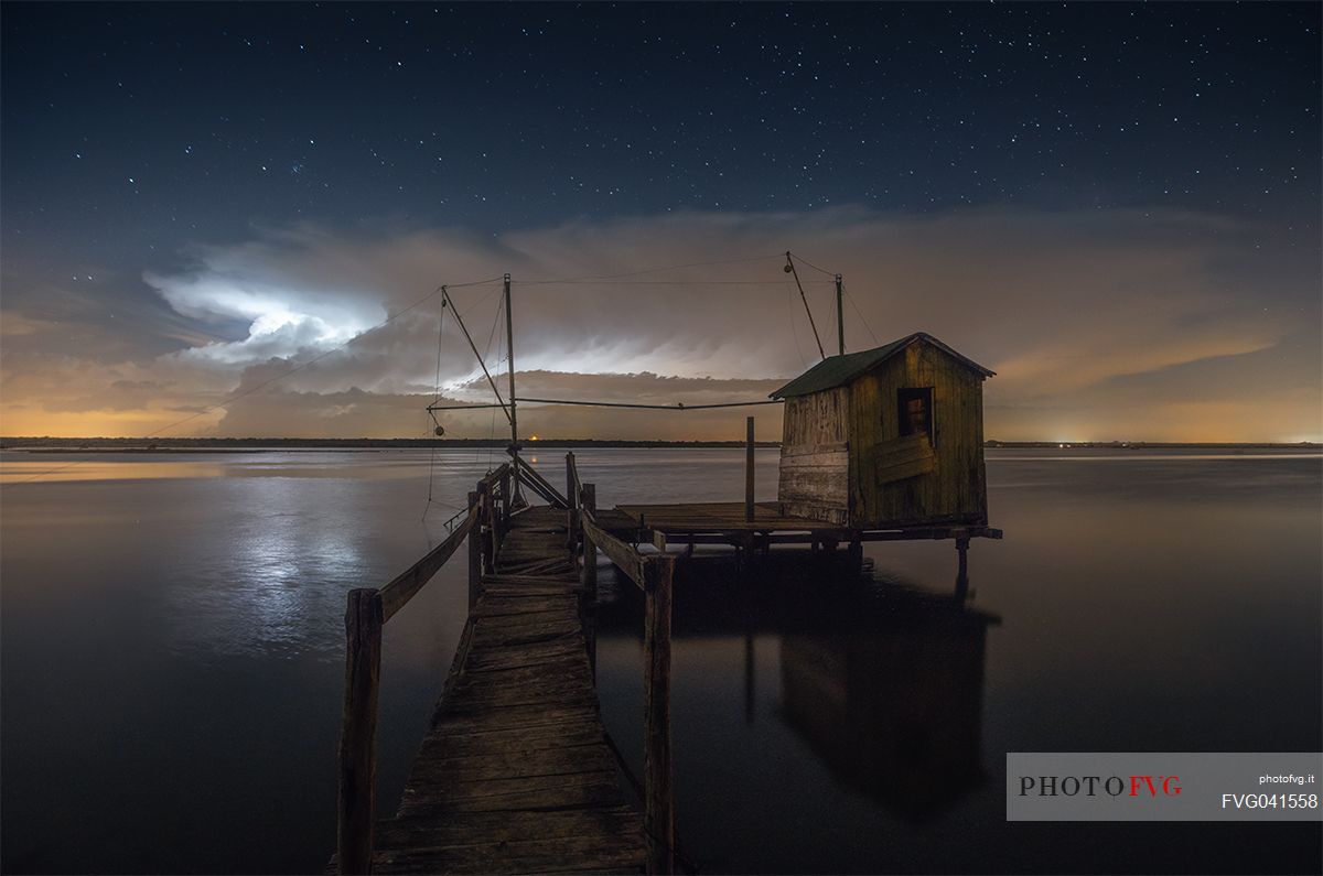 Lightning over Adriatic Sea with typical fishing house in Marina di Ravenna, Emilia Romagna, Italy, Europe