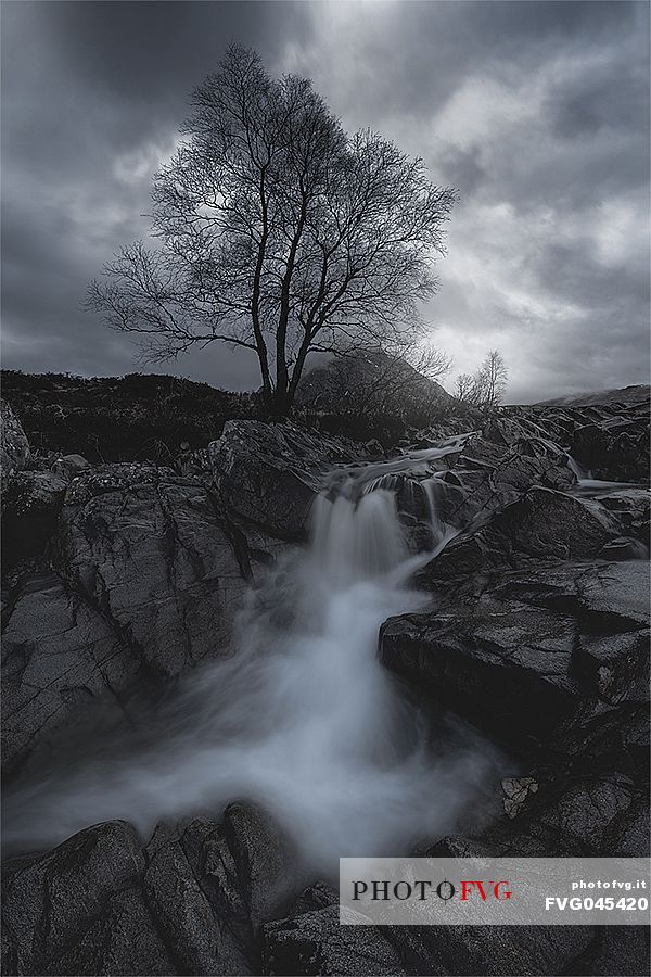 Cloudy day at Coupall Falls on River Coupall and Buachaille Etive Mor mountain, Highlands, Scotland, Europe