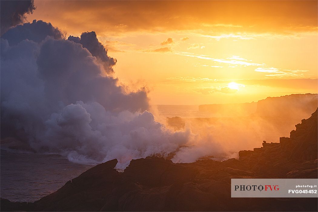 Lava flowing into the Pacific Ocean at sunset, Kilauea Volcano, Hawaii Volcanoes National Park, Big Island, Hawaii, USA