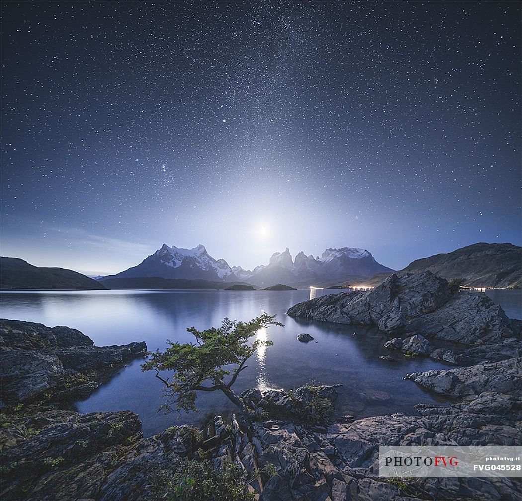 milky way and the moon over torres del paine from lake Pehoe, Patagonia, Chile