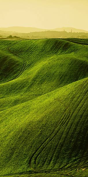 sunrise over the Crete Senesi in a misty morning