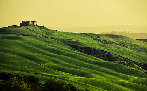 sunrise over the Crete Senesi in a misty morning