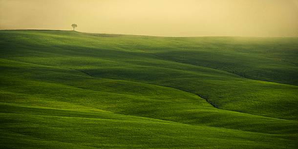 sunrise over the Crete Senesi in a misty morning